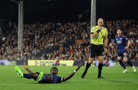 Arsenal's Bukayo Saka claims a penalty which referee Anthony Taylor (right) gives.