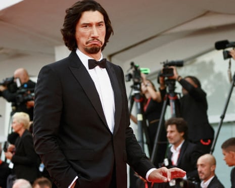 Adam Driver pulls a long face on the red carpet for the premiere of Ferrari at the 2023 Venice Film Festival