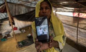 Nur Asha with a photograph of the sons she lost in Myanmar. 