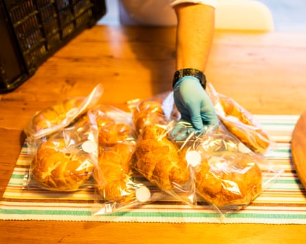 Gloved hand placing individually wrapped food catering service on film set