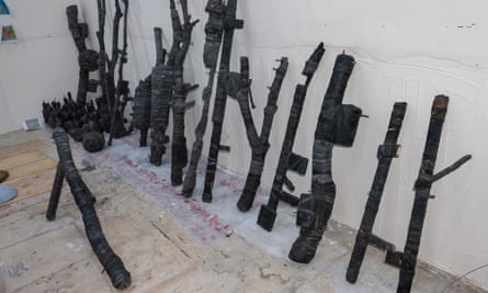 Replica black guns lined up against a wall
