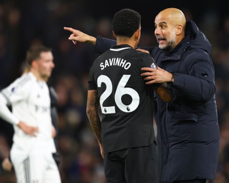 Pep Guardiola gestures to the City midfielder Savio during a chaotic match at Fulham