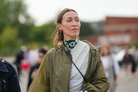 a woman in a green jacket