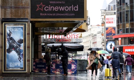 People walk past a Cineworld in Leicester Square in London