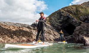 Paddlers exploring rugged cave