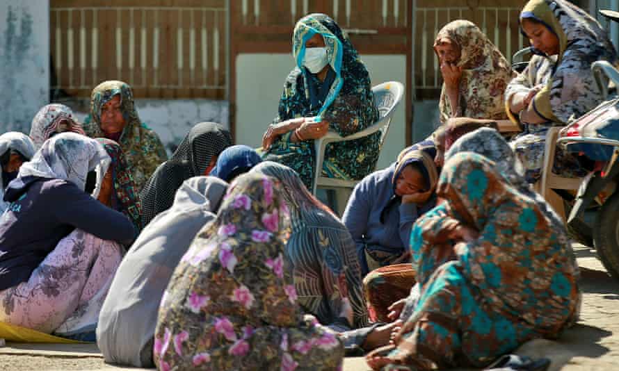 Relatives of the Patels gather to mourn their deaths at the family’s home in Dingucha.
