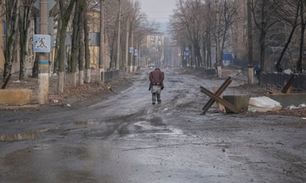 A man walks along an empty street in Bakhmut.