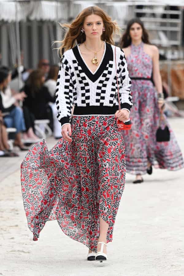 Model wearing chequered-flag sweater and skirt