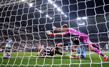 Savinho of Manchester City scores his team's first goal past Newcastle keeper Aaron Ramsdale.