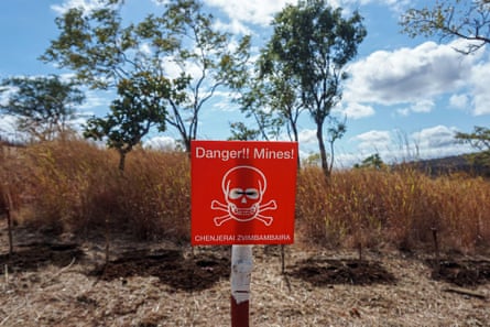 A red sign with a skull and crossbones and the words ‘Danger! Mines!’ and ‘Chenjerai Zvimbambaira’