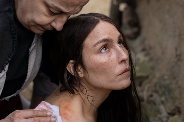 A still from the movie You Won't Be Alone with a woman being tapped on the shoulder by a man