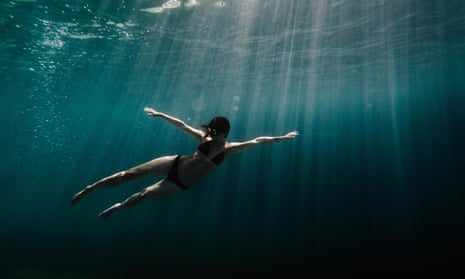 Woman swimming underwater in the ocean