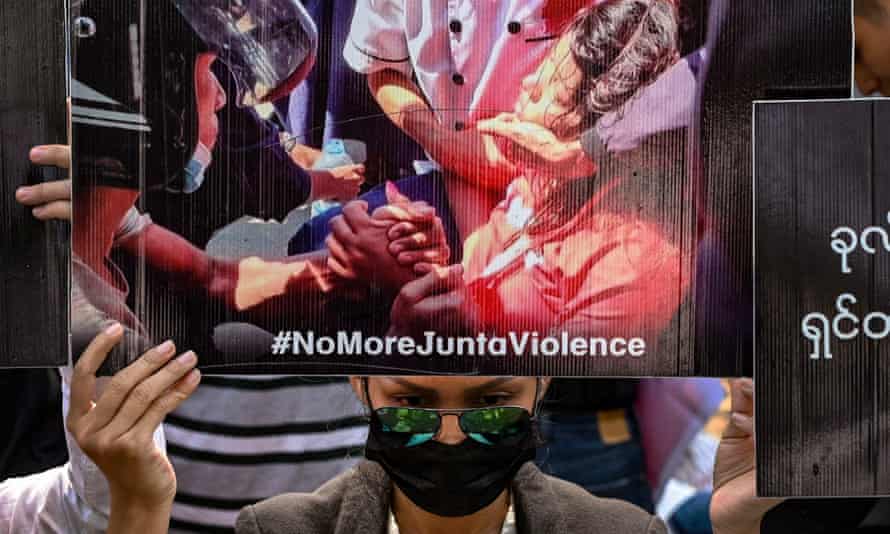 A protester holds up a poster