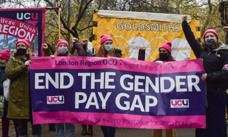 Demonstrators hold an End the Gender Pay Gap banner during a University and College Union strike and protest in London in 2021.
