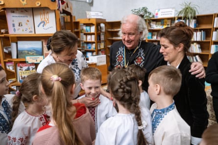 Raechel Isolda, left, ‘prime mover’ of the books donation project, Ed Vulliamy and the library’s director, Alla Gordiienko, with children at the library.