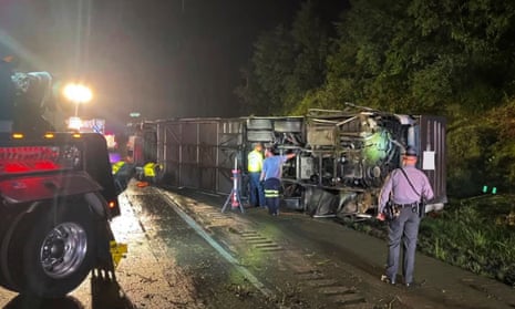 Police and rescue workers arrive on the scene of the bus crash in Lower Paxton Township, Dauphin county, Pennsylvania, on 6 August. 