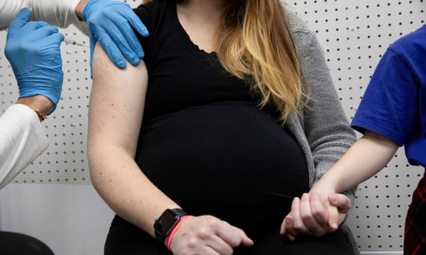 A pregnant woman receives a vaccine for the coronavirus disease (COVID-19)