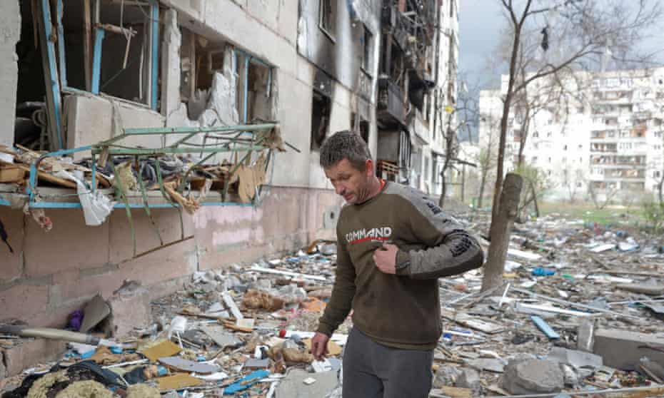 A man walks amid debris of a residential building damaged by a military strike in Severodonetsk, Luhansk