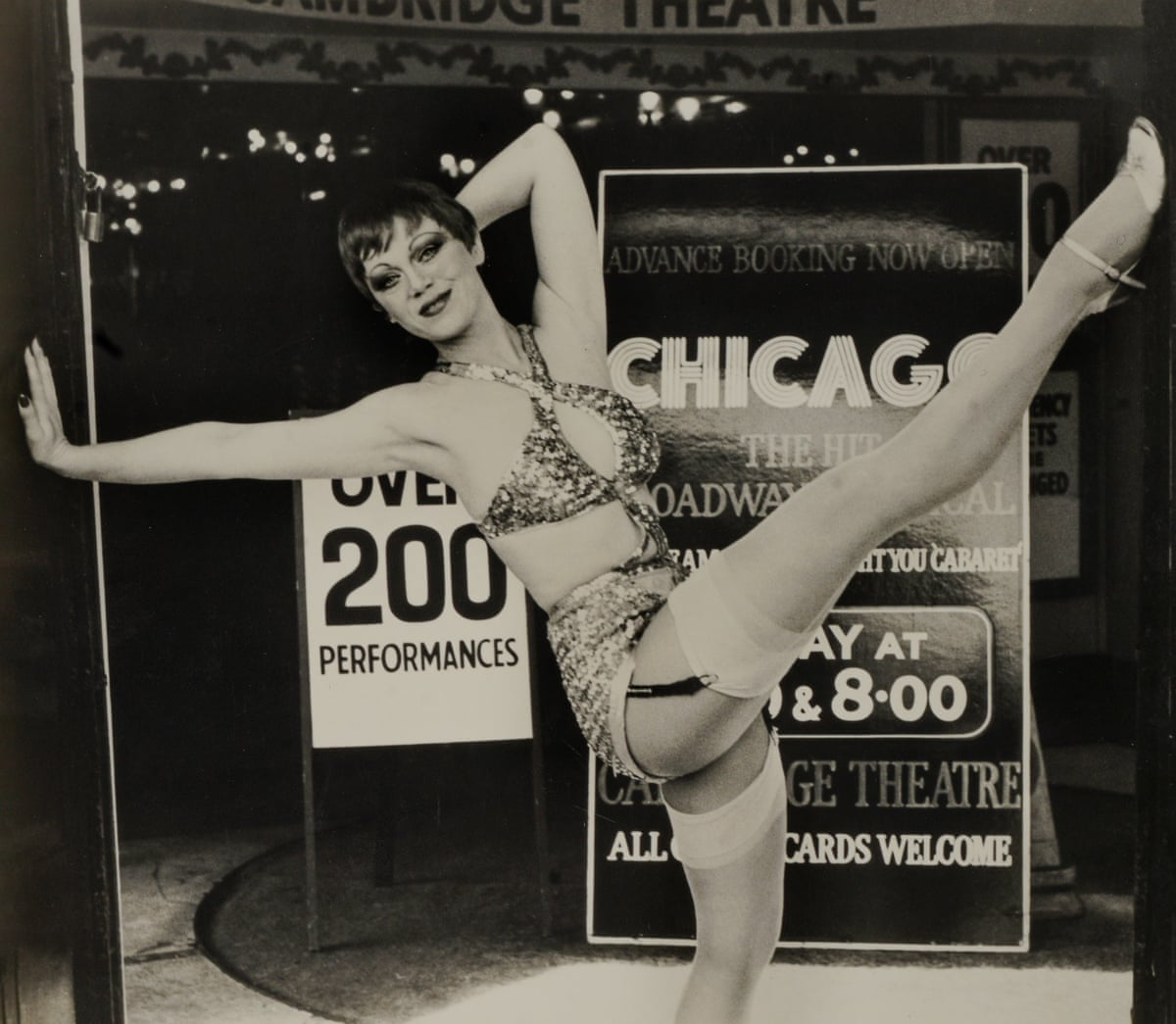 Jacquie Toye high-kicking her leg in front of a Chicago poster
