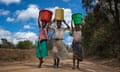 Girls carrying water buckets in Malawi.