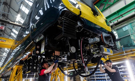 Staff work on a new train carriage at the Alstom train  plant in Derby, England.