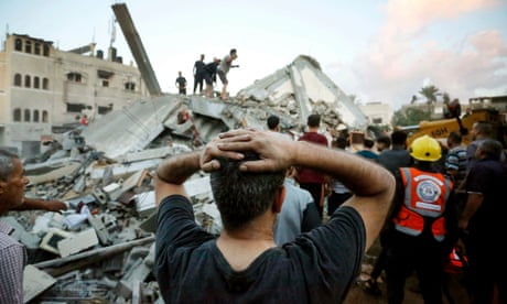 Rescuers and civilians remove the rubble of a home destroyed after an Israeli attack in central Gaza.