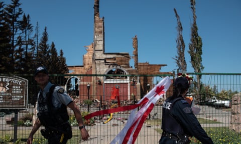 Firefighters inspect the damage at the burned-out Roman Catholic St Jean Baptiste church in Morinville, Alberta, Canada.