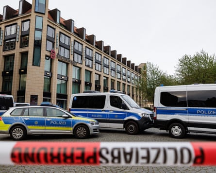 Police vehicles are parked behind a cordon at the scene of the crash in Leipzig