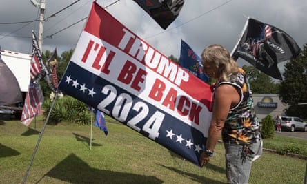 Unofficial campaign flags and buttons for Donald Trump are consistent sellers at a roadside vendor tent in northern Alabama, where the former president drew a crowd of several thousand supporters last month.