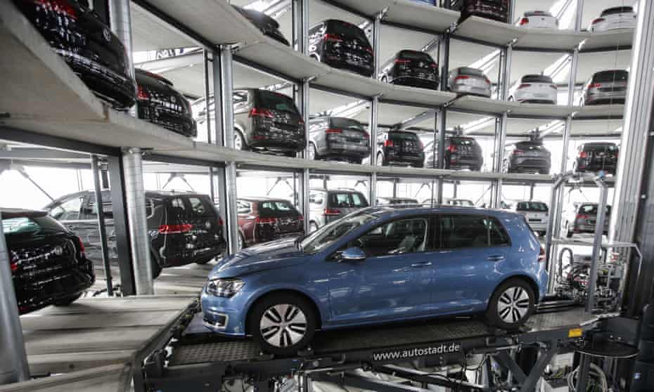 A Volkswagen Golf makes its way through a delivery tower at the company’s Wolfsburg headquarters.