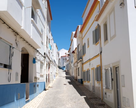 Narrow street in Portugal of two storey white houses