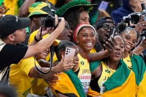 Shelly-Ann Fraser-Pryce of Jamaica and teammates celebrate with fans after winning silver in the women’s 4x100m relay final.