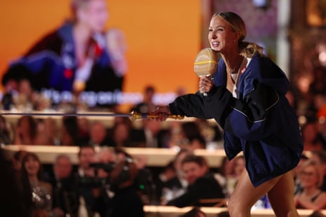 woman swings while holding a ping-pong racket and sword