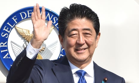 Shinzo Abe waves to wellwishers before boarding a plane for America.