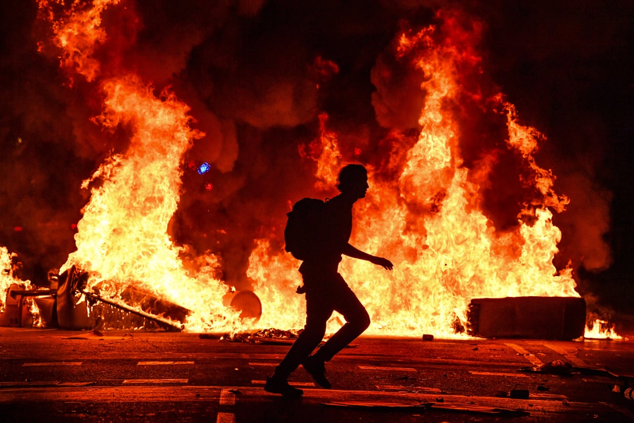 Fires burn after an evening of rioting in Barcelona, Spain