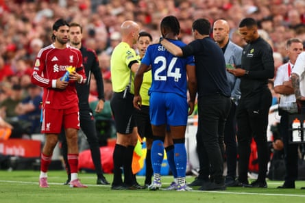 Referee Anthony Taylor talks to Liverpool manager Arne Slot and Bournemouth manager Andoni Iraola after Antoine Semenyo was racially abused by a fan at Anfield