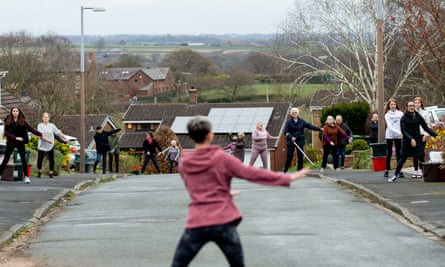Janet Woodcock leads her neighbours in Frodsham during a socially distanced dance they are doing every day in lock down.