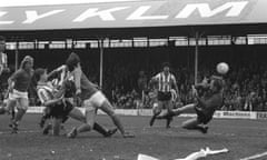 Brentford goalkeeper Paddy Roche palms away an effort by Neil Webb of Portsmouth, during the League Division Three match at Griffin Park in 1983.