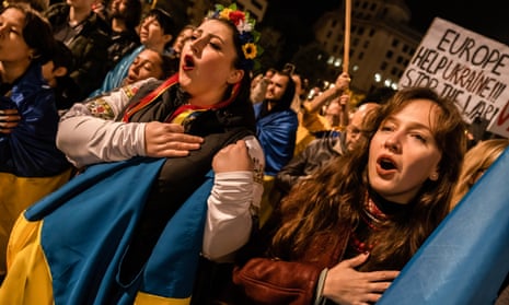 Protesters sing Ukraine’s national anthem in Barcelona.