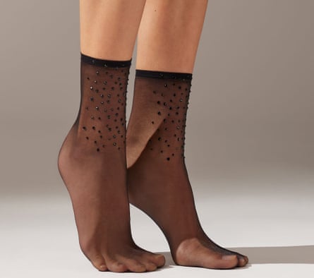 A model wearing sheer short diamanté socks stands on her tiptoes