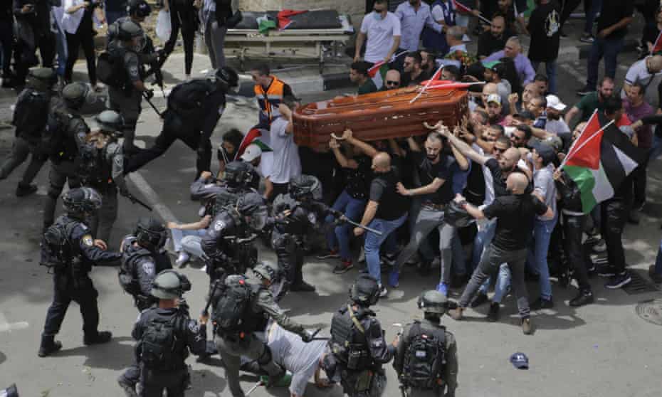 Israeli police confront mourners as they carry the coffin of journalist Shireen Abu Akleh in Jerusalem, 13 May 2022. 