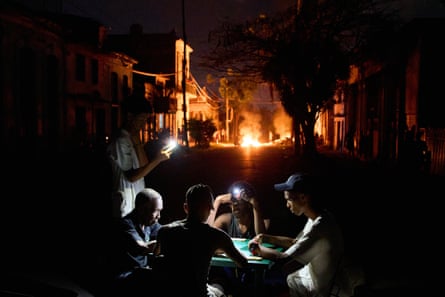 Dominoes by phonelight during a blackout in Havana, May 2026.