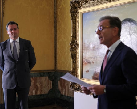 The two men standing near the Turner painting