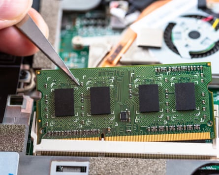 Close up of a RAM Stick being inserted in a Memory Slot on a laptop