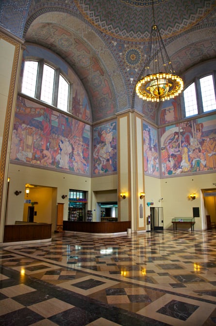 And ornate art deco lobby with a huge arch and murals.