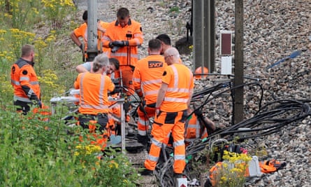 SNCF engineers work to repair damage to the TGV line at Croiselles in northern France