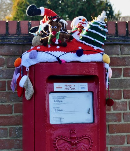 Festive knitted items on a postbox in 2021