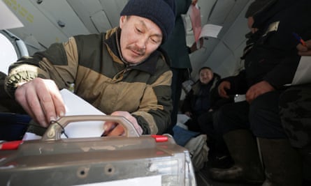 Reindeer herder Dmitry Neustroyev casts his ballot during early voting in north-eastern Siberia