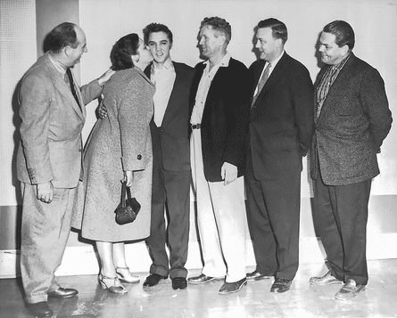 Big money … at the RCA contract signing in 1955 with Parker, left, and Presley’s parents Gladys and Vernon either side of him.