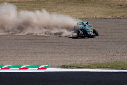 Fernando Alonso spins through the gravel after going off